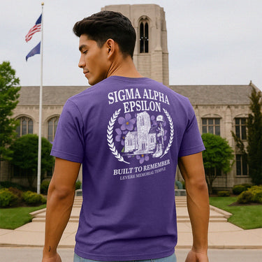 Fraternity man wearing purple short sleeve t-shirt depicting the Sigma Alpha Epsilon (SAE) Levere Memorial Temple on the back.