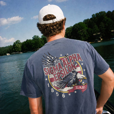 Man wearing a blue comfort colors tee with premium america design