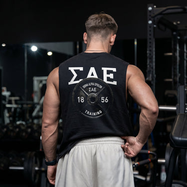 Man wearing a black cut off tank with premium grunge gym design