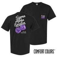 Comfort Colors High Roller Tee shown front and back, featuring a small dice graphic on the chest pocket and a large casino-inspired dice design on the back.