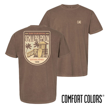 Brown Comfort Colors Surf Club Social T-shirt featuring a small front logo and a large surf club back graphic.