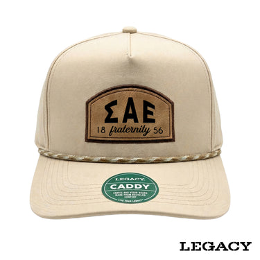 Cream Legacy brand rope hat featuring a brown fraternity patch, designed for stylish fraternity apparel and casual campus wear.