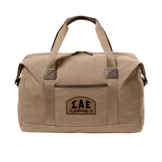 Fraternity Tan Canvas Duffel Bag with leather patch on front.